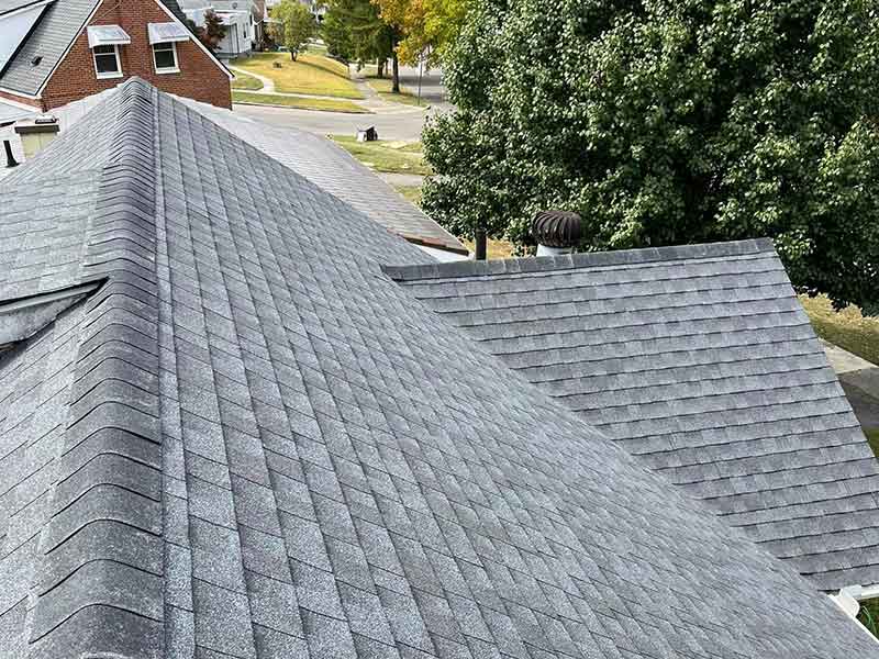 Residential roof with new gray shingles installed by DR Roofing & Painting LLC