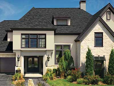 Beige, mid-class home with black GAF shingles on its roof