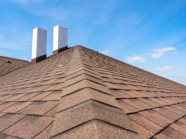 Close up of brown asphalt shingles on a residential roof