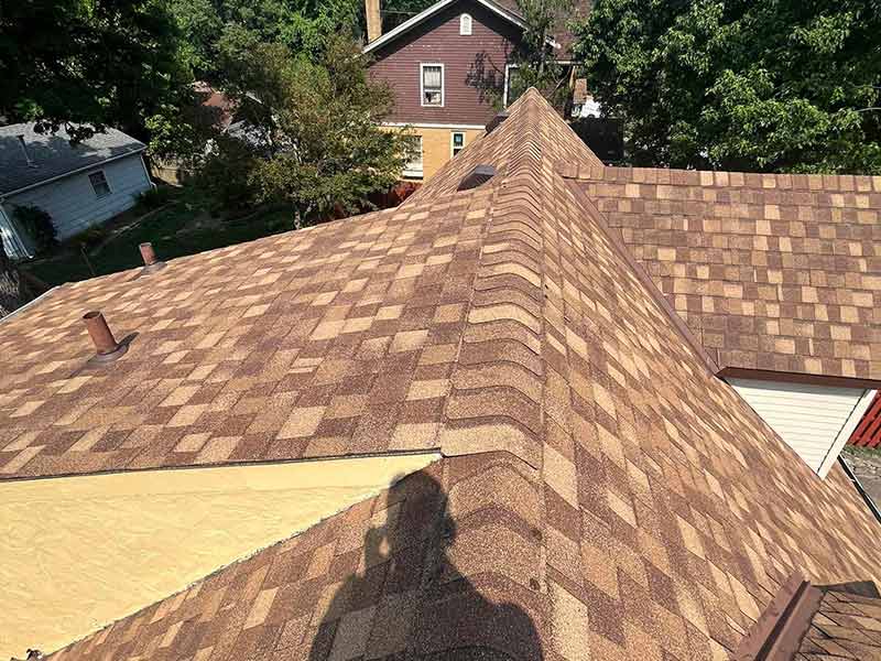 Residential roof with new light brown shingles installed by DR Roofing & Painting LLC